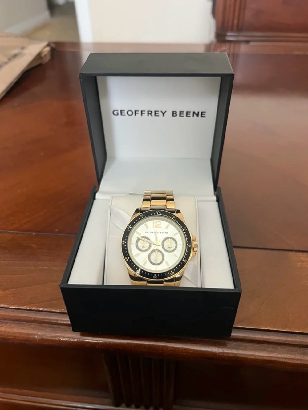 Geoffrey Beene Gold Tone Chronograph Watch with Black Bezel